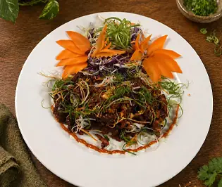 Garnished meat dish with carrot carvings